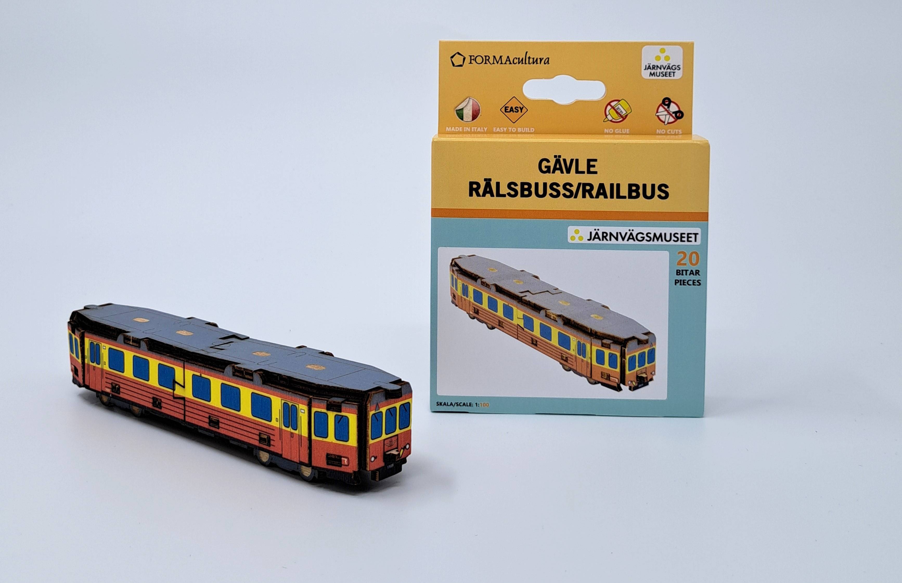 En rälsbuss i miniformat står bredvid en förpackning med byggsats för rälsbuss.