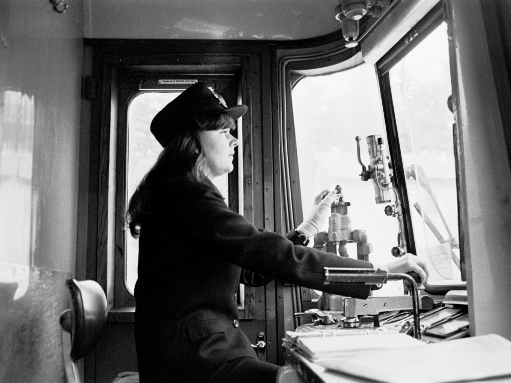Female conductor in the driver's cab.